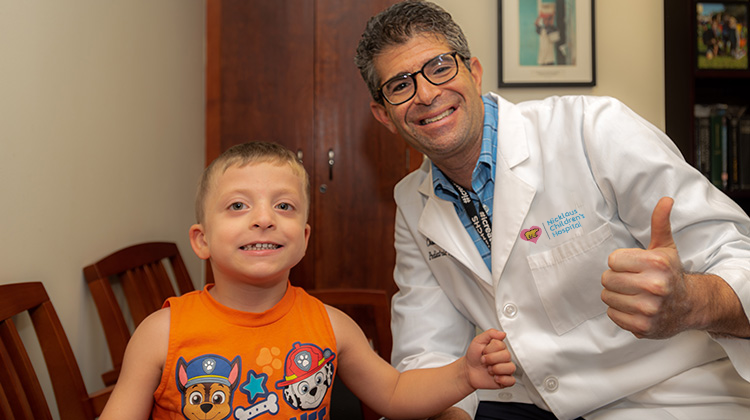 Dr. Perlyn and a young boy treated by the BWS clinic.