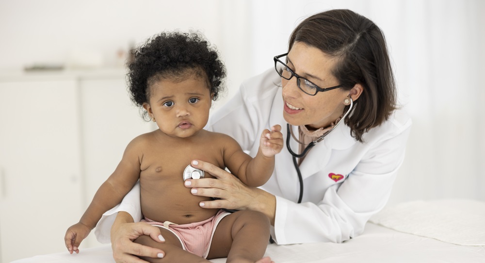 Female doctor with baby girl patient