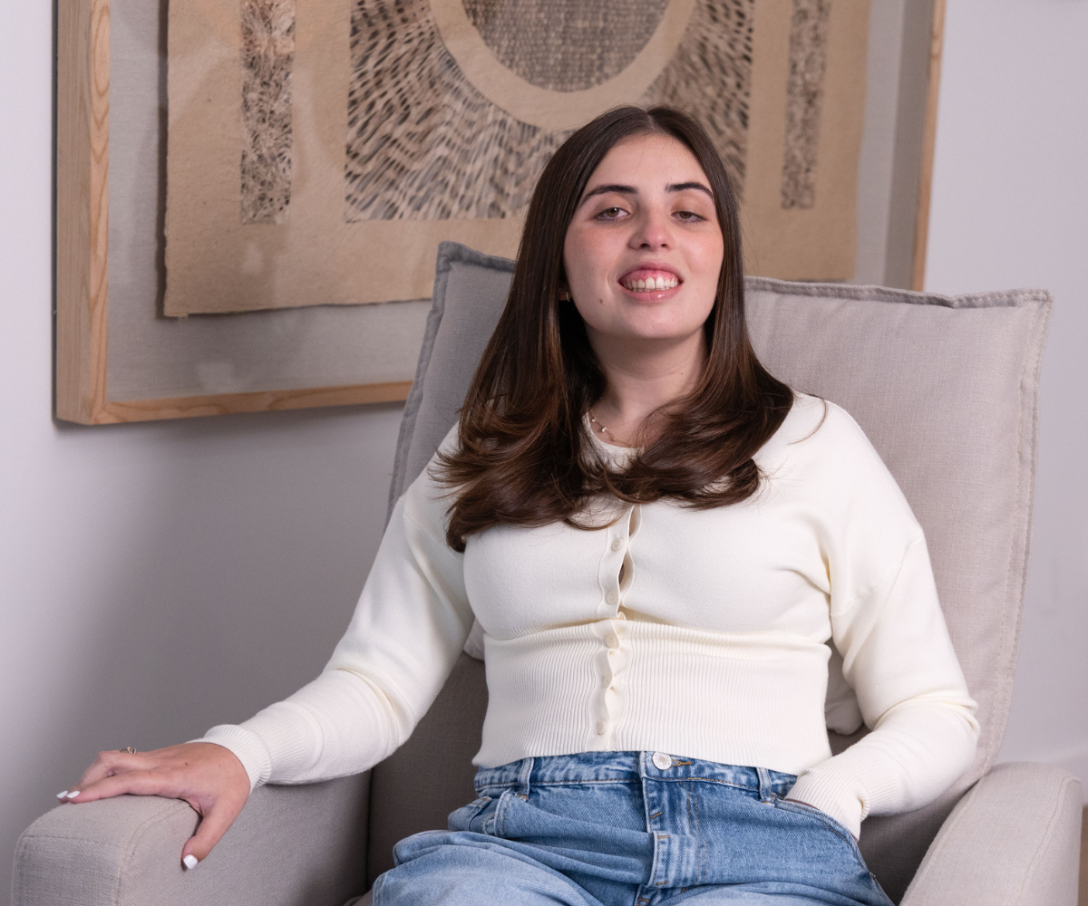 Katy squeezing her arm muscle showing strength