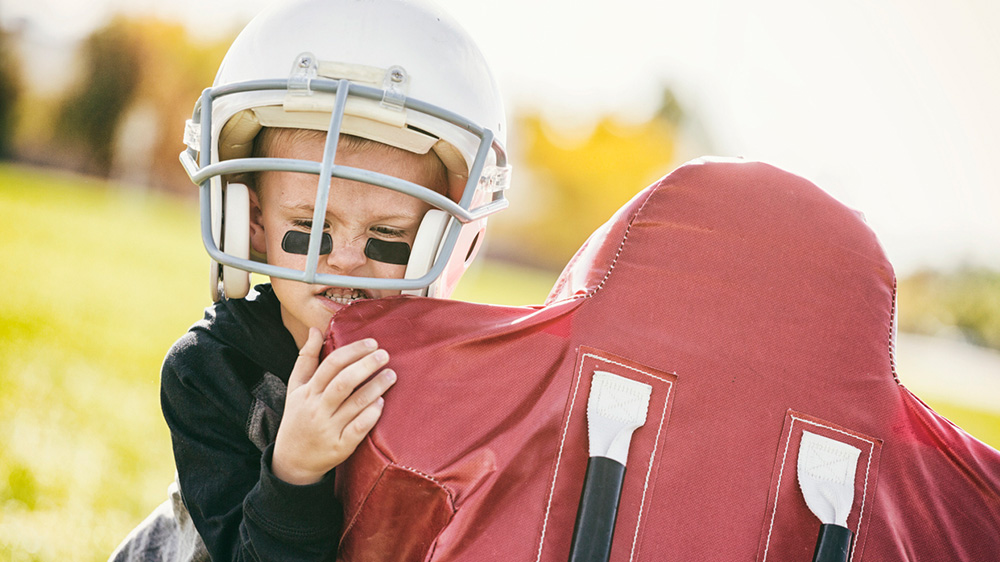 boy during practicing a football tackle.