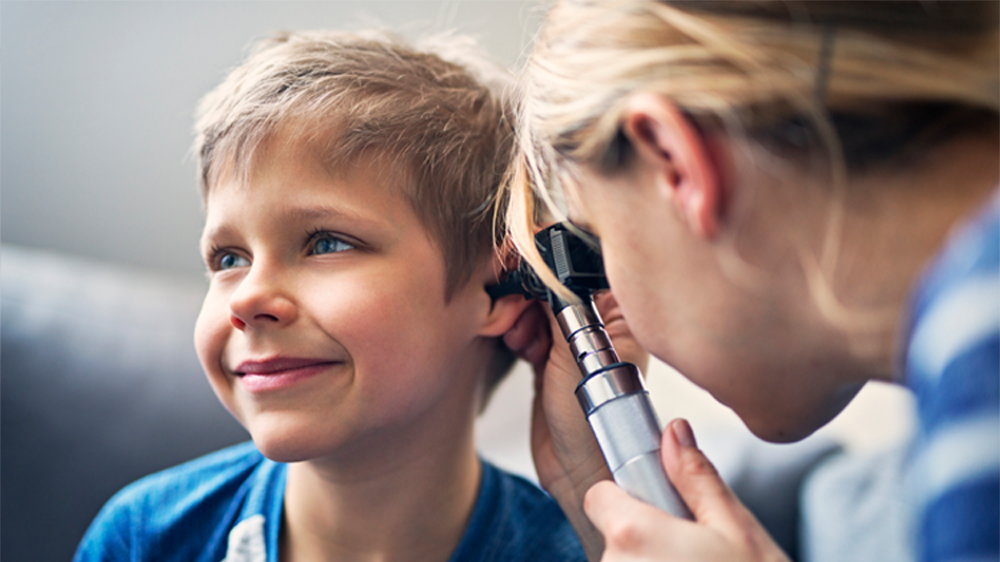 boy receiving ear exam.