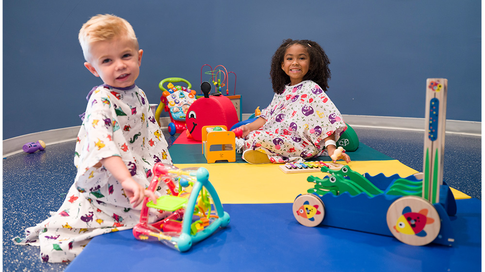 two children playing in the play room.
