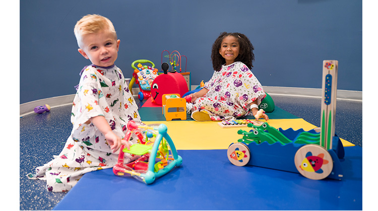 two children playing in the play room.