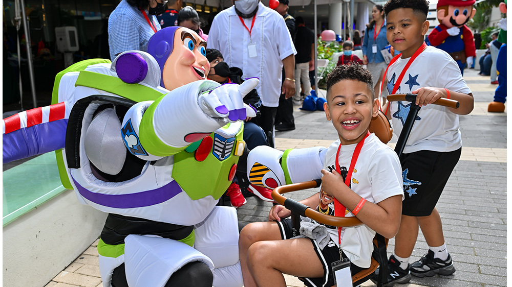 patient boy greeted by costumed cartoon character.