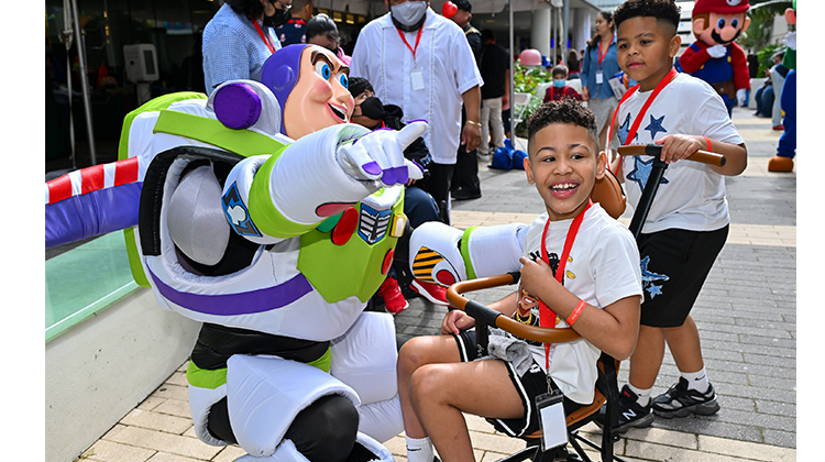 patient boy greeted by costumed cartoon character.