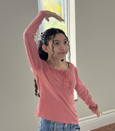 elizabeth strikes a dance pose.