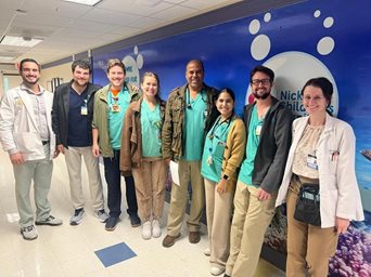group photo of staff celebrating in hospital courtyard