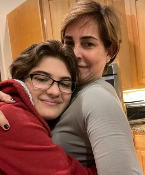 Mo with hugging her daughter